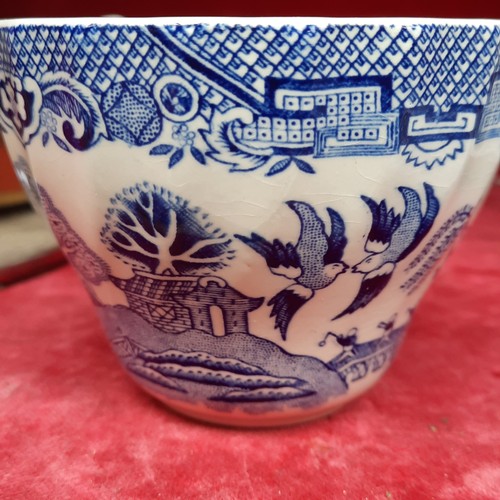 416 - A group of Churchill Blue Willow pattern blue-and-white tableware, including cups and saucers, dinne... 