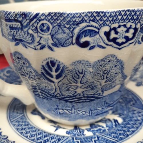 416 - A group of Churchill Blue Willow pattern blue-and-white tableware, including cups and saucers, dinne... 
