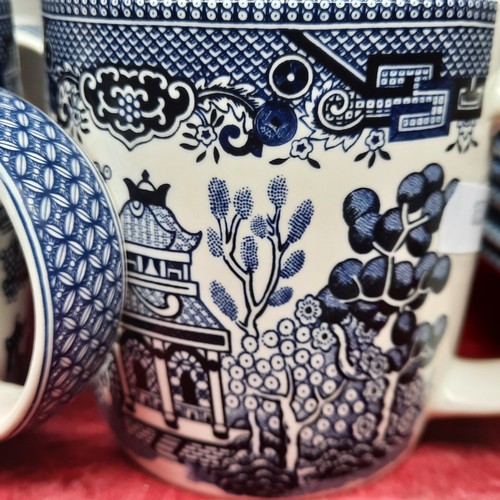 416 - A group of Churchill Blue Willow pattern blue-and-white tableware, including cups and saucers, dinne... 