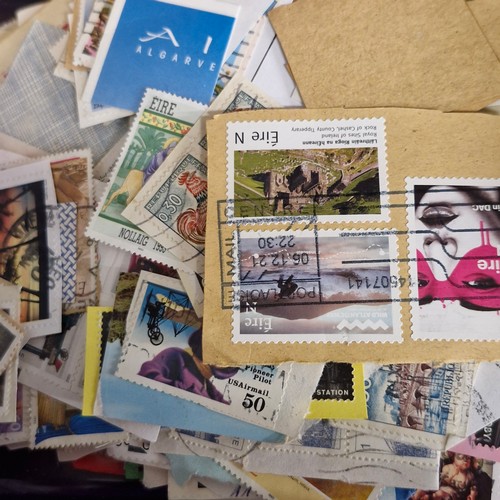 377 - A vintage stamp album, loose irish stamps on paper and a selection of 195Os letters with irish stamp... 