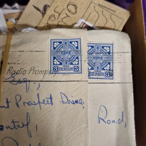 377 - A vintage stamp album, loose irish stamps on paper and a selection of 195Os letters with irish stamp... 
