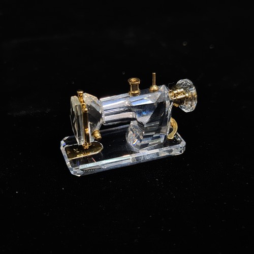 143 - Two Swarovski Crystal Memories from the retired line. Lot includes a statuette of a sewing machine a... 