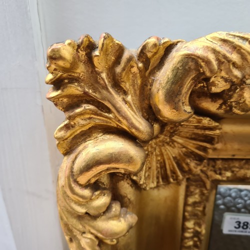 389 - Star Lot : A lovely large Antique gilt horizontal mirror with scroll , shell and foliate motifs. Dim... 