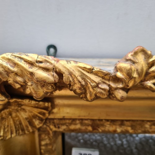 389 - Star Lot : A lovely large Antique gilt horizontal mirror with scroll , shell and foliate motifs. Dim... 