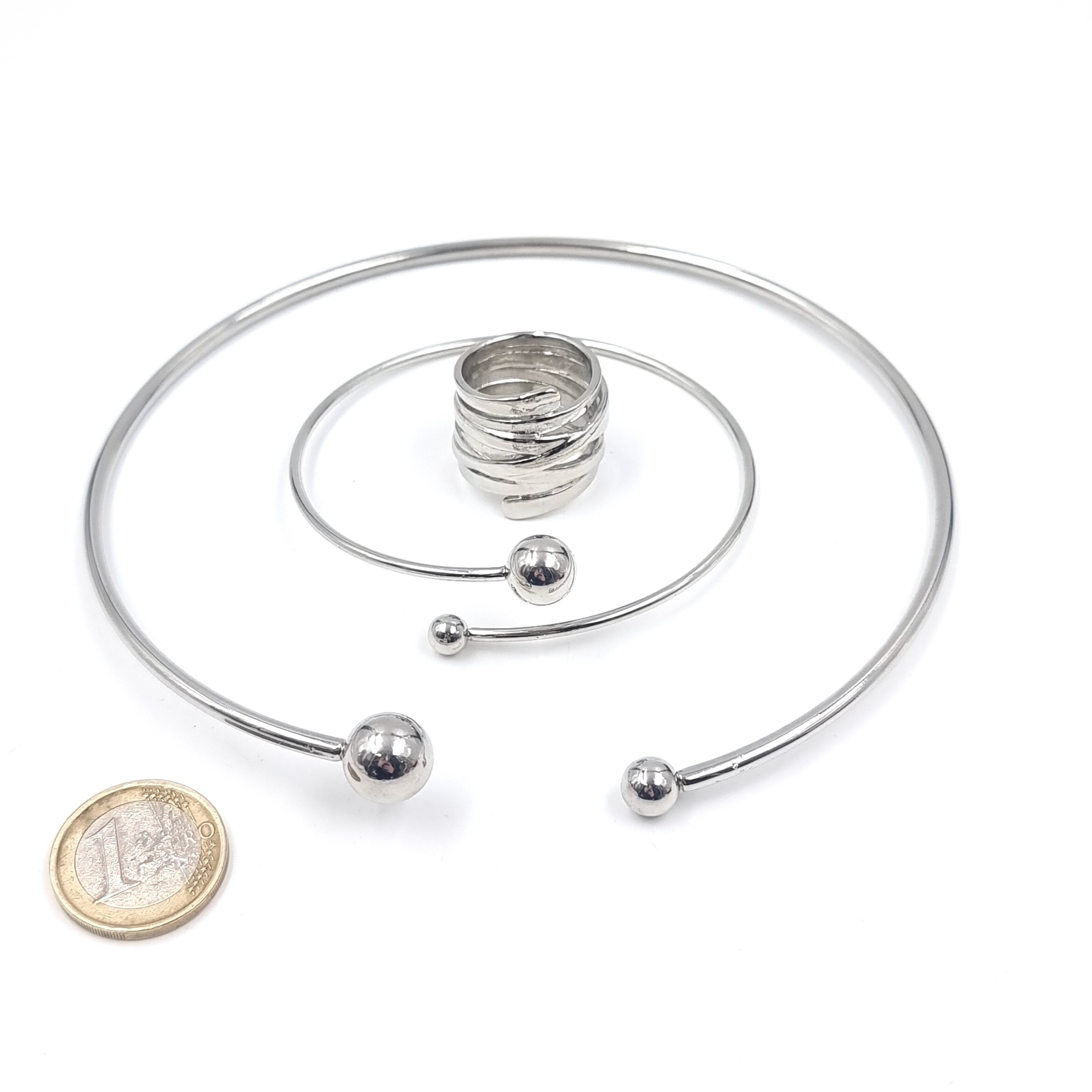 A modernist barrel ring with a matching torc choker and bangle. Total ...