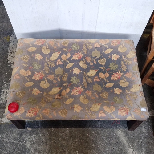 A large vintage rectangular upholstered stool, the cushion in leaf ...