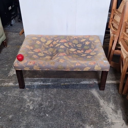A large vintage rectangular upholstered stool, the cushion in leaf ...