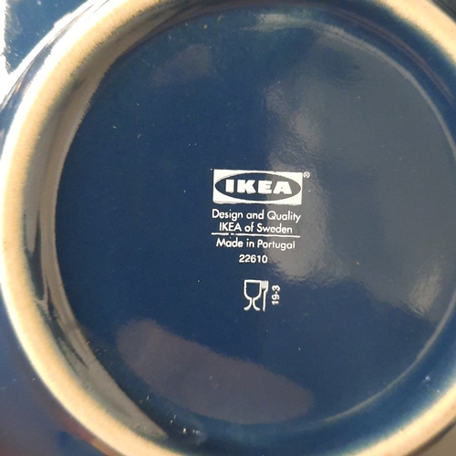 A group of IKEA stoneware tablewares in dark blue glaze, comprising dinner plates, side plates and b
