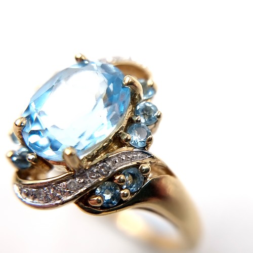 Star Lot: A fabulous twist mount Diamond and Topaz ring set in nine ...