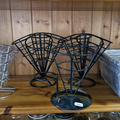 A group of modern metal kitchen and catering ware, comprising wire cone ...