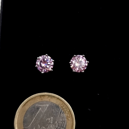 A pair of sterling silver pink tourmaline stud earrings.