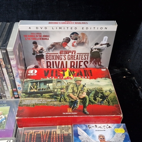 A mixed group of DVDs and compact discs, including ESPN Boxing’s ...