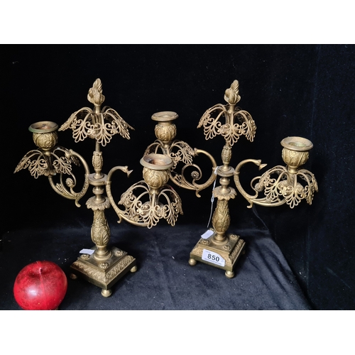 Star Lot: A stunning pair of late 19th century ormolu two knopp candelabras, the scroll arms raised above a leaf decorated baluster column on a square platform base with bun feet, 32.5cm high. Gorgeous look to these.
