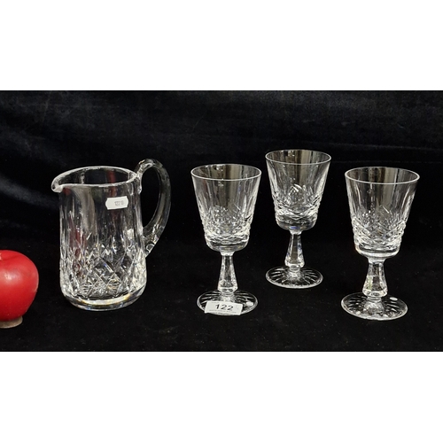 122 - Four Waterford Crystal pieces including a Whiskey water jug in the Lismore pattern and three glasses... 