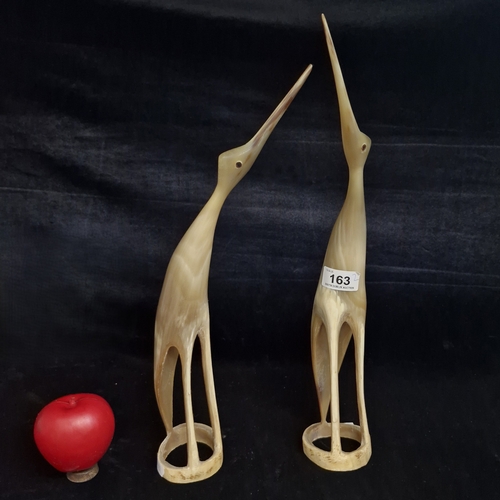 163 - A pair of tall vintage hand carved bird sculptures made from animal horn. Stylized, slander silhouet... 