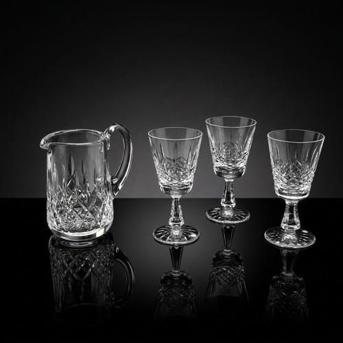 122 - Four Waterford Crystal pieces including a Whiskey water jug in the Lismore pattern and three glasses... 