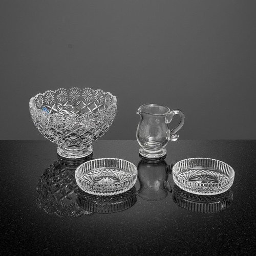 134 - Four glass and crystal pieces including two ash trays, a hand blown jug with pontil mark, and a larg... 