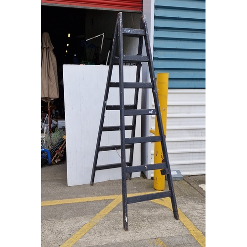 A tall 7 Rung Painter’s timber step ladder, painted black, of A-frame ...