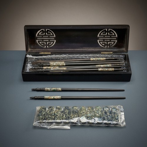 179 - A nice lot of Vietnamese chopsticks and chopstick rests featuring Mother of Pearl accents. Housed in... 