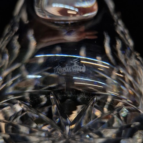 122 - Four Waterford Crystal pieces including a Whiskey water jug in the Lismore pattern and three glasses... 