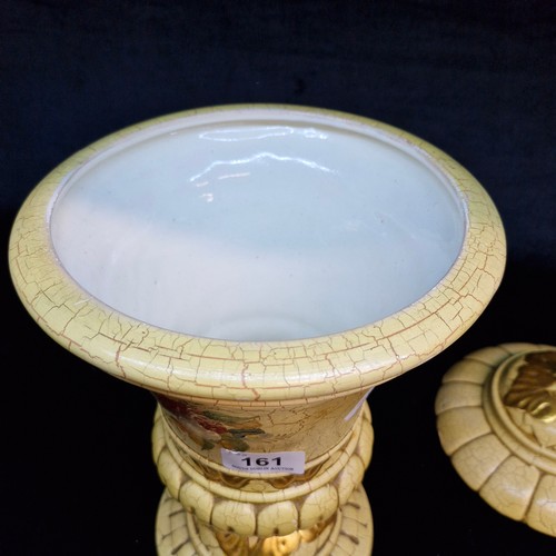 161 - A large decorative ceramic vase with a lid featuring a distinct cream-coloured crackle glaze, gilded... 