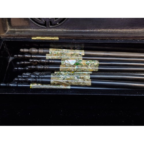 179 - A nice lot of Vietnamese chopsticks and chopstick rests featuring Mother of Pearl accents. Housed in... 