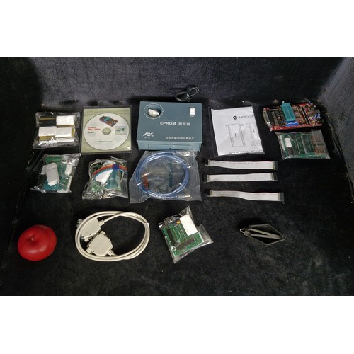 A box of electronic components and microcontroller programming ...
