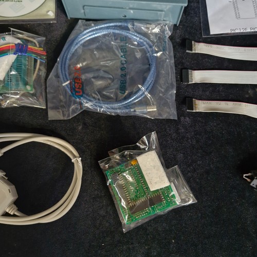 A box of electronic components and microcontroller programming ...