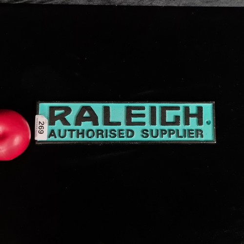A painted cast iron wall sign reading 'Raleigh Authorised Supplier'