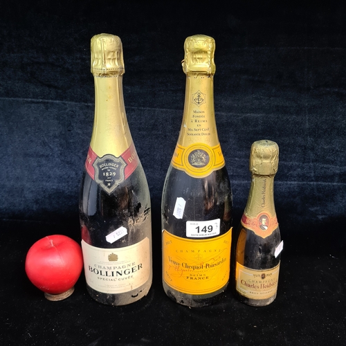 149 - An alcohol trio including a bottle of Veuve Clicquot Ponsardin Brut Champagne 71.99€, a bottle of Bo... 