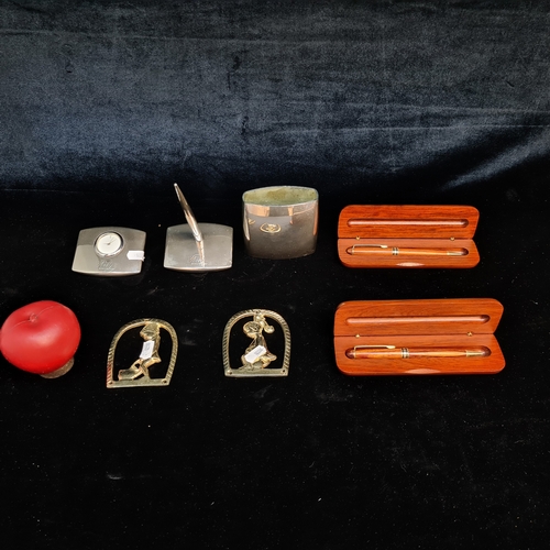 152 - A mixed lot of Seven items including two VHI branded chrome desktop clock and pen, a pair of brass t... 
