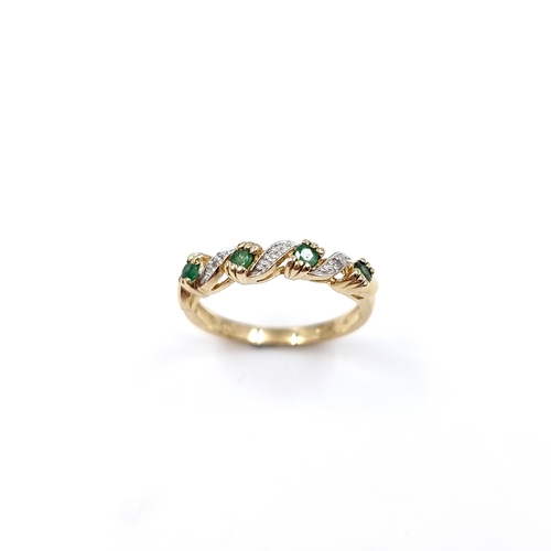 11 - Star Lot: A lovely vintage example of a  Diamond and Emerald twist mounted ring set in nine carat. S... 