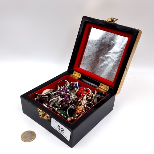 52 - A large collection in excess of 45 assorted gemstone rings. Contained in a gilt lacquered box.