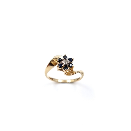 9 - Star Lot: A stunning Diamond and Sapphire daisy style ring. Set in nine carat gold. Size - M, Weight... 