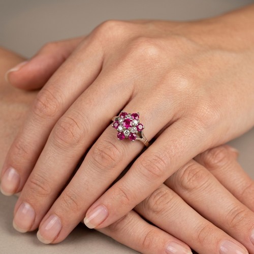 3 - A Ruby cluster ring set in nine carat / 925 Silver. Size - N 1/2, Weight - 1.83 grams. Please note, ... 