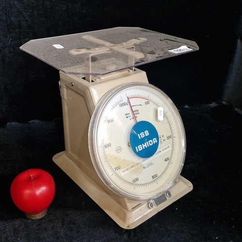 1572 - Ishida mechanical postal scale, the circular dial calibrated to 1000g with red indicator, set on a p... 