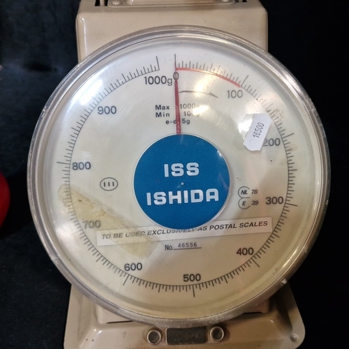 1572 - Ishida mechanical postal scale, the circular dial calibrated to 1000g with red indicator, set on a p... 