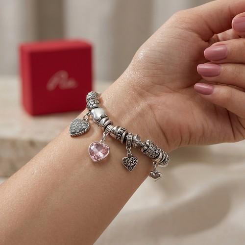 53 - Two Sterling Silver bracelets set with Pandora style charms. Total weight - 80 grams. Please note, t... 