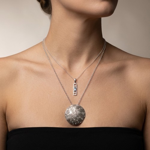 36 - A Sterling Silver Swirl designed pendant necklace and chain. Together with a further Sterling Silver... 