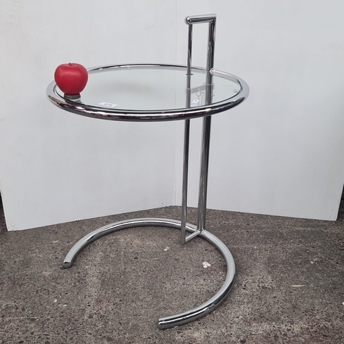 Star Lot : An Eileen Gray E1027 chrome-tubular side table, the circular glass top within a ring gallery, supported on an adjustable upright with square-section handle and security chain, above a cantilevered C-form base.
Eileen Gray (1878–1976) was a pioneering Irish furniture designer and architect, regarded as one of the most influential figures in modern design. She became famous for her elegant Art Deco and Modernist furniture, including the iconic E-1027 adjustable table and Bibendum chair. Gray's innovative use of materials and timeless designs have made her work highly sought after by collectors, and she is celebrated as one of Ireland's greatest designers.