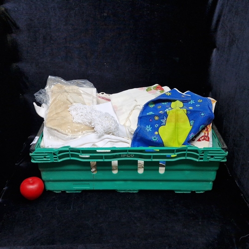 A quantity of white linen household textiles including drawn-threadwork and bobbin-lace trims, floral cutwork doilies, needlepoint panels with red-and-blue borders, and a blue cotton child’s apron printed with a green kangaroo and stylised flowerheads. From the ambassadors residence in Silchester Road, in Glenageary.