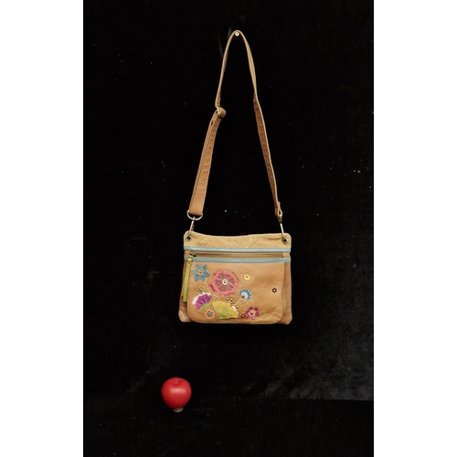 A leather Fossil bag with leather patchwork floral design and shoulder strap. In good condition.