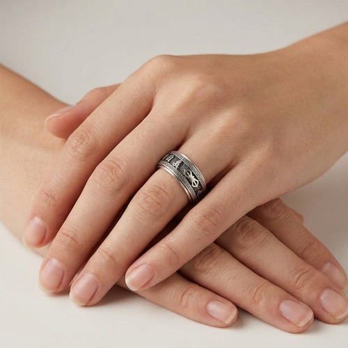 22 - A gents sterling silver articulated, spinning  ring, showing Asian script. Size V. Weight - 9.2 gram... 