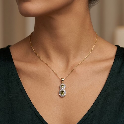 10 - Star Lot : A diamond and citrine figure 8 pendant. Set in 9ct gold. Weight - 1.62 grams.
