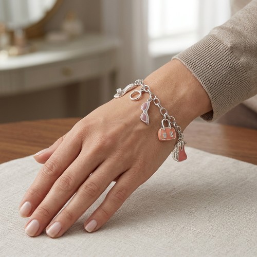 17 - A sterling silver 5 charm bracelet. Weight - 13.5 grams.