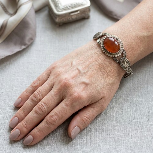 33 - A sterling silver bracelet set with amber cabochon stone mount. Total weight - 28 grams.