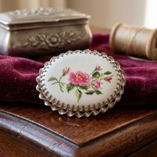 16 - A hand painted brooch. Set in sterling silver. Sign to reverse 