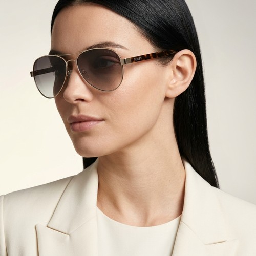 44 - A pair of Guess designer aviators style gold metal frame sunglasses. Lenses in good clean condition.... 