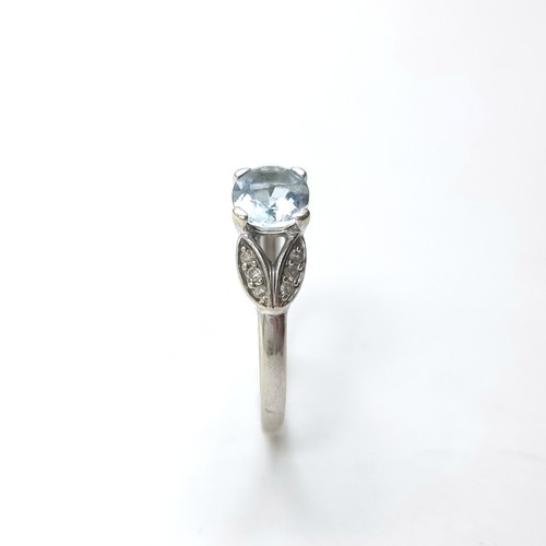 4 - Star Lot : A stunning large aquamarine gemstone ring. Set in 9ct white gold with diamond shoulders. ... 