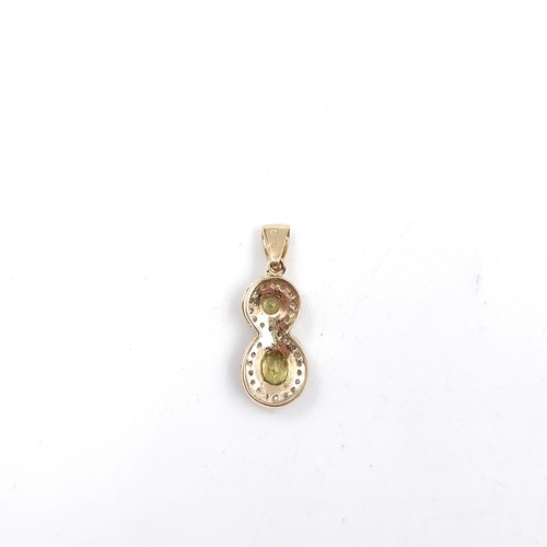 10 - Star Lot : A diamond and citrine figure 8 pendant. Set in 9ct gold. Weight - 1.62 grams.